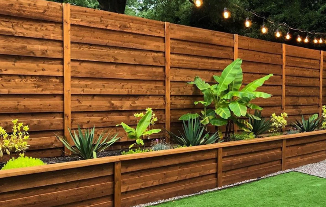 wood fences in front of a yard